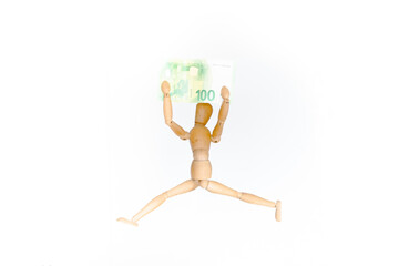 wooden mannequin jumping with money in hands with white background. Wooden figure with a 100 euro bill. economic concept