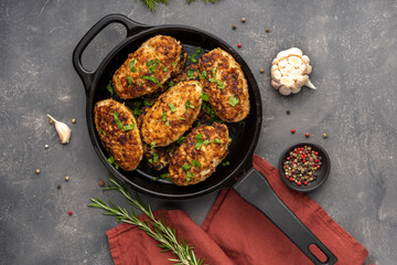 Meat cutlets in frying pan over background. Herbs and spices. Top view, flat lay. High quality photo