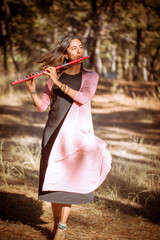 Indigenous woman playing the flute