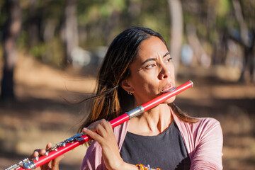 Indigenous woman playing the flute © topshots