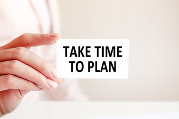 TAKE TIME TO PLAN written on a card in woman hand