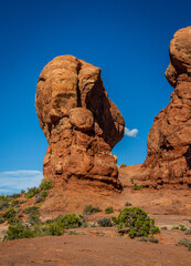Portrait shot of two red sandstone monoliths agains blue sky in arches national park in utah, america