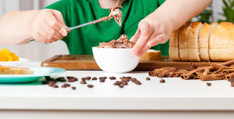 a child prepares sweets in the kitchen