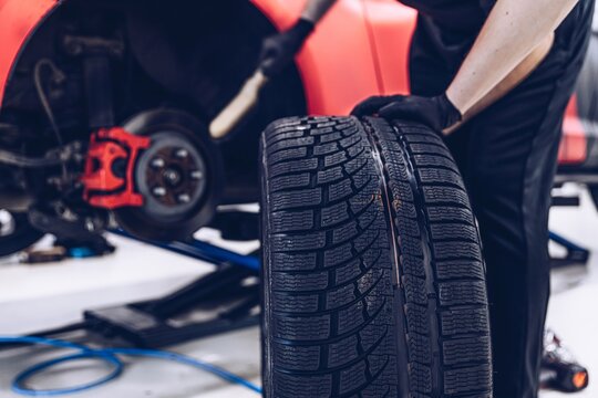 Changing car tire and wheel in the professional car mechanical service