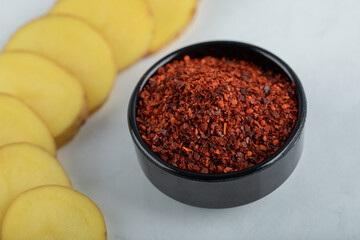 Macro photo of red hot chili pepper and potato slices