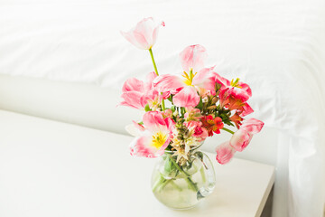 bouquet of flowers near the bed