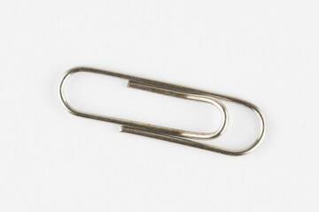 silver paperclip on a white background