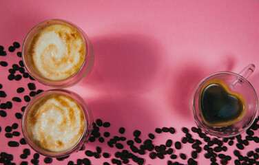 Fresh espresso coffee cups with milk on a pink background. View from above. Flat lay.