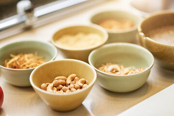 Ceramic bowls full of different nuts and other ingredients