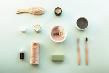 Top view hygiene items and natural cosmetics on blue background. Beauty, spa and wellness concept.