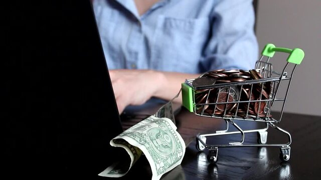Young woman hands taking money from shopping cart on the white room background. Travel concept. Close up.