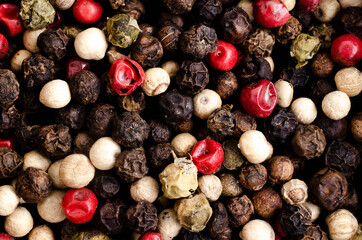 Black, white, green, and pink peppercorns. Top view. 