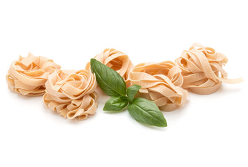 Italian pasta fettuccine nest and basil leaves  isolated on white background cutout