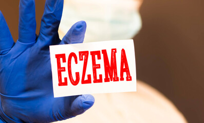 Doctor holding a card with text Eczema medical concept