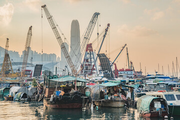 Boats in Hong Kong harbour at sunset time.