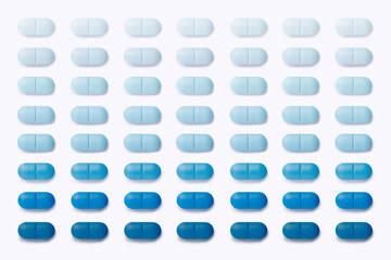 Trendy pattern made with gradient blue pharmaceutical medicine pills, tablets and capsules on bright background. Medicine creative concept. Minimal visual style. Flat lay.