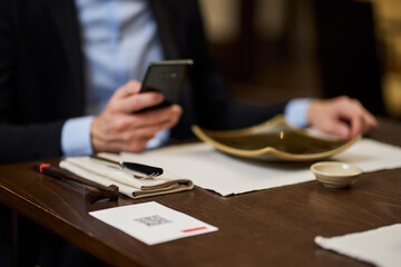 Restaurant using his phone to locate a menu