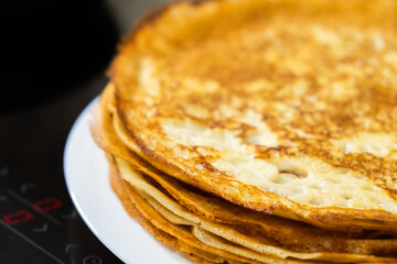a stack of pancakes on a white plate
