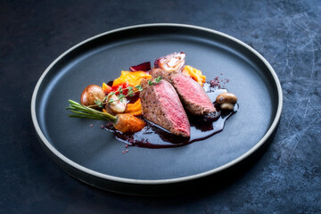 Modern style traditional wild hare back filet braised with wild berries and red wine jus with...