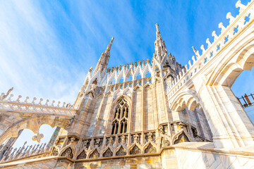 Roof of Milan Cathedral Duomo di Milano with Gothic spires and white marble statues. Top tourist...
