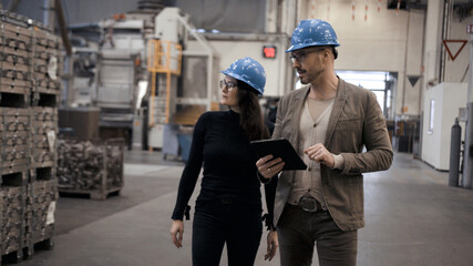 man and woman business meeting in industrial plant