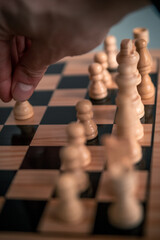 Chess pieces set up ready to play chess game on a wooden board strategy game head to head white making move with pawn