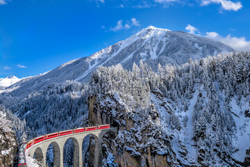 Swiss red train in winter time  - obrazy, fototapety, plakaty