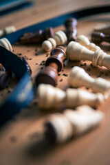 Chess pieces on a wooden table close up photo