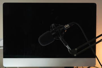 Podcast microphone on dark background.