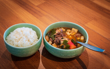 Bowl of white rice and Korean spicy tofu stew, called Sundubu Jjigae