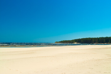 beach.in the photo, the sea shore against the blue sky