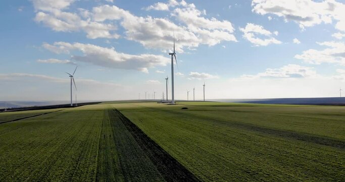 Scenery Of Windmill Turbines In Green Meadows During Summertime. - Aerial Drone Shot