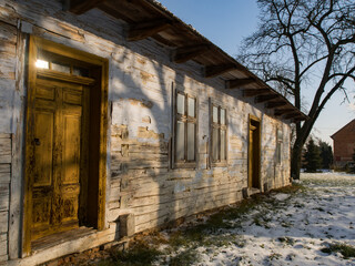 Fototapeta premium White wooden log house with yellow door