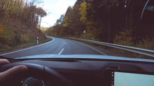 hands of car driver on steering wheel, road trip, driving on highway road
