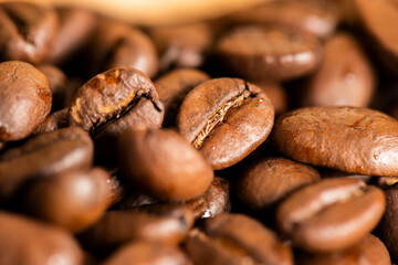 Detailed closure of roasted coffee beans, food background.