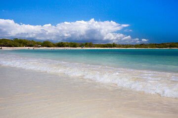 Idyllic beach scene with clear blue water, blue sky and sandy shore seen from Puerto Rico