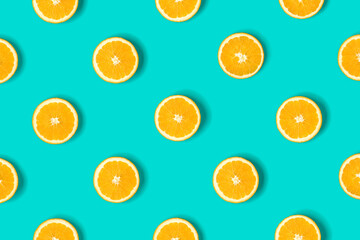 Fruit pattern of orange slices on blue background. Flat lay, top view. Food background.