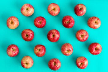 Fruit pattern of red apple on blue background. Flat lay, top view. Pop art design, creative summer concept. Food background.