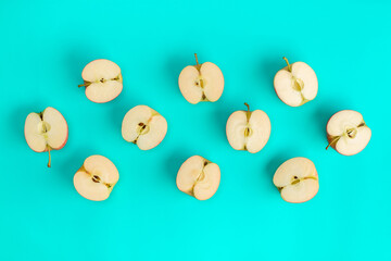 Fruit pattern of apple halves on blue background. Flat lay, top view. Food background.