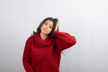 Young woman in red warm sweater suffering from headache