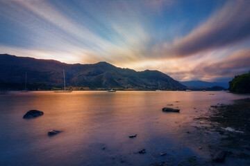 Blue and Gold Sunset at Wanaka Lake -view from Eely Point Recreation Reserve. Wanaka is a popular...