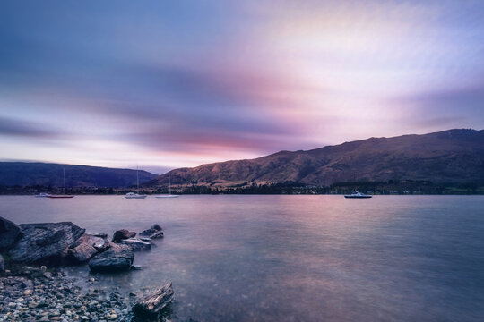 Colorful Sunset at Wanaka lake-front from Eely Point Recreation Reserve. Wanaka is a popular ski and summer resort town in the Otago Region of the Southern Island of New Zealand.