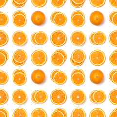 Seamless pattern of orange fruit slices. Orange slices isolated on white background. Food background. Flat lay, top view.