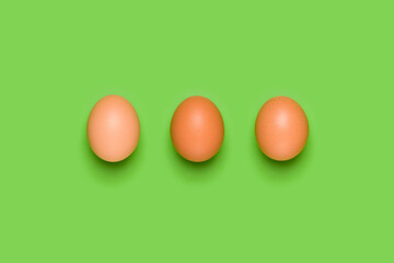 Eggs pattern on green background. Easter concept. Flat lay, top view. Food background.