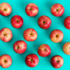 Fruit pattern of red apple on blue background. Flat lay, top view. Pop art design, creative summer concept. Food background.