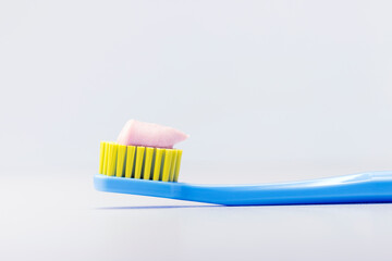 Toothbrush with toothpaste on gray background with copy space. Dental concept.