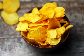 Cheese chips in a bowl. Yellow cheese chips.