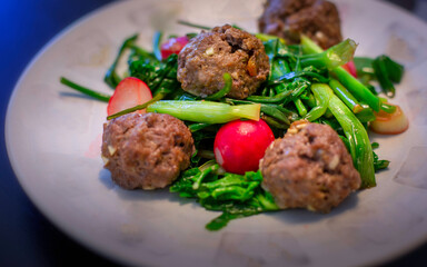 Meatballs with spinach, scallop, scallion, and red radish.