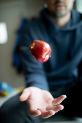 man holding a red apple in his hand