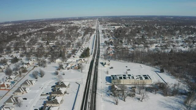 Busy 4 lane road partially cleared after a snow storm